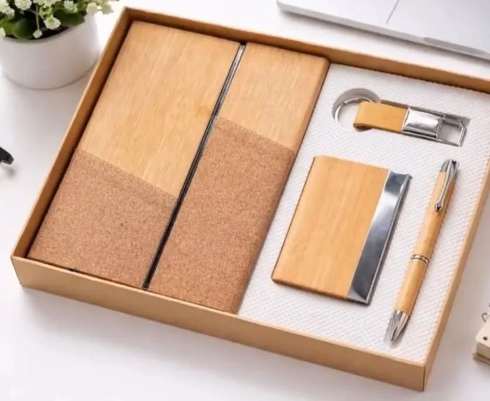 A notebook with a bamboo-finish and cork cover, a bamboo-finish card holder with a steel edge, a bamboo-finish pen and a…