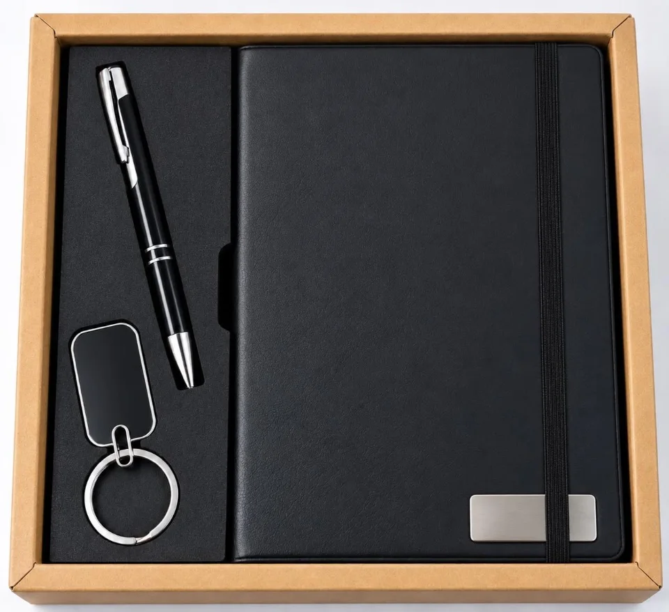 Black notebook, pen and keychain in a kraft box